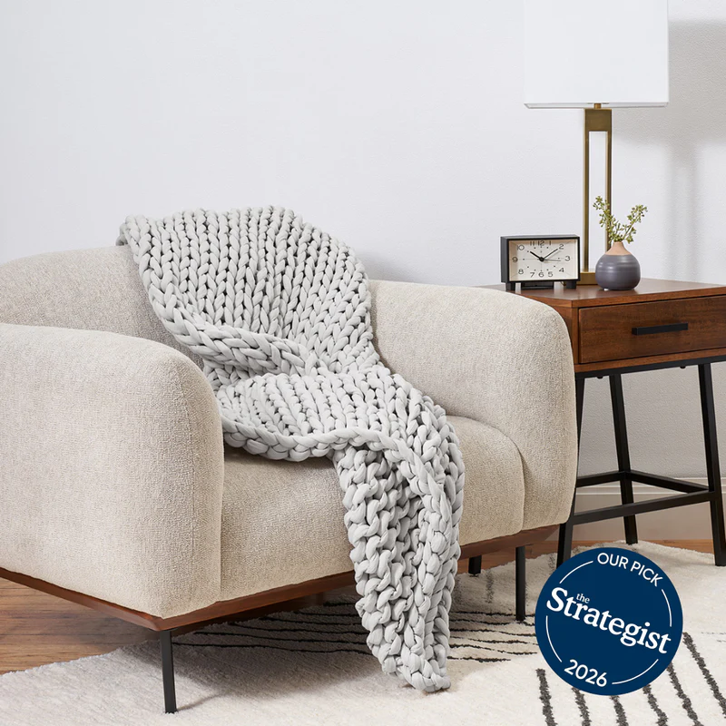 Bearaby Cotton Napper weighted blanket draped over a living room chair