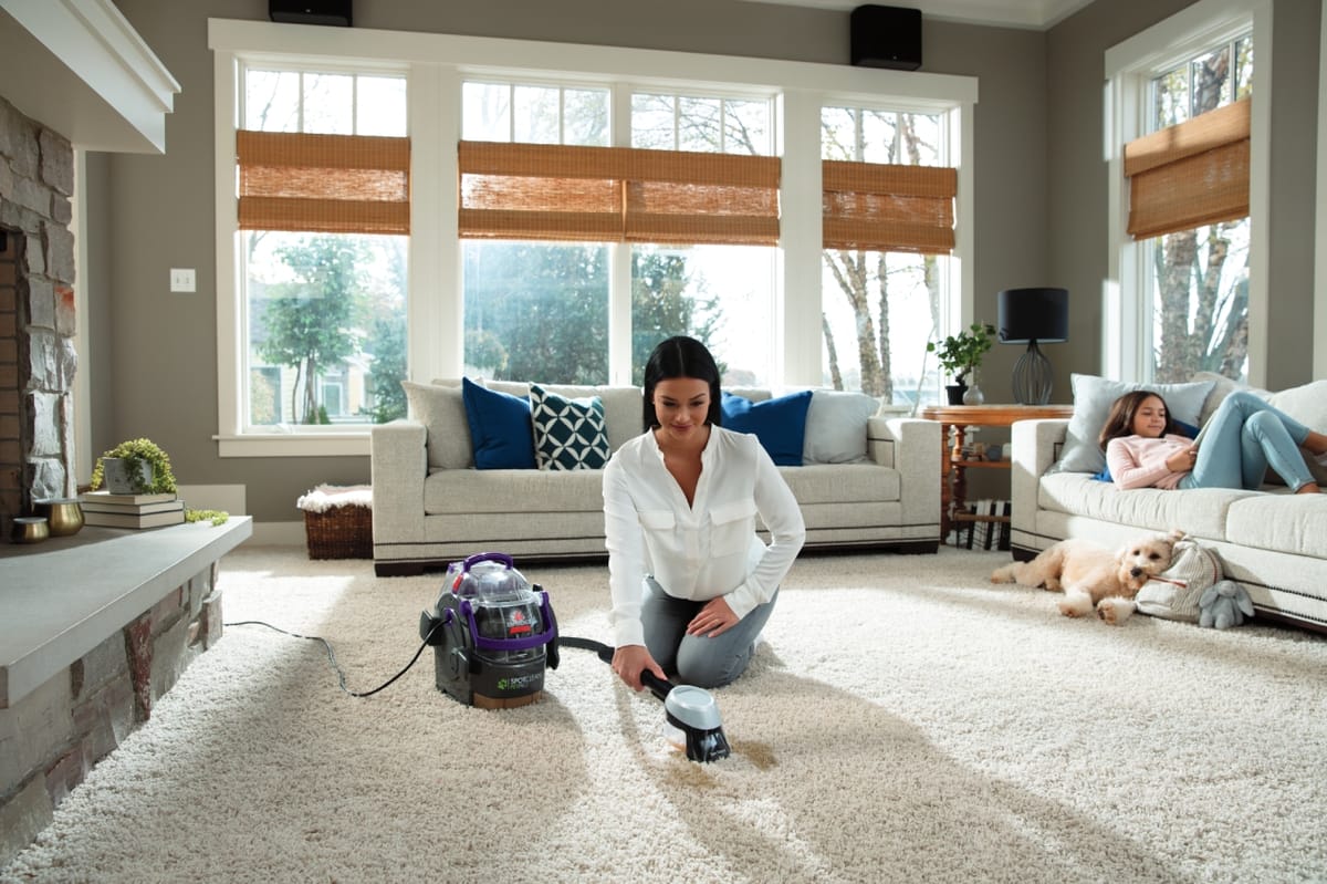 Bissell SpotClean Pet Pro used in a living room for carpet stain cleanup