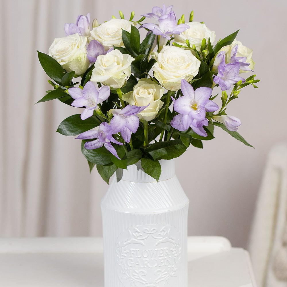 Bunches Freesias and Roses bouquet with white roses and lavender freesias