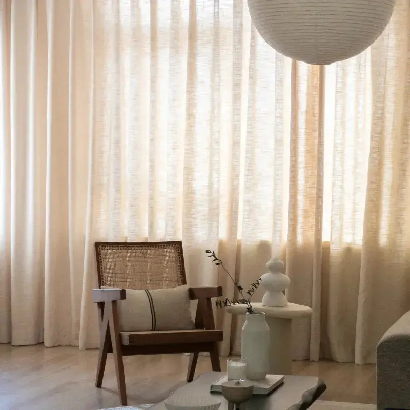 Sand beige TWOPAGES Liz linen drapes framing a bright window